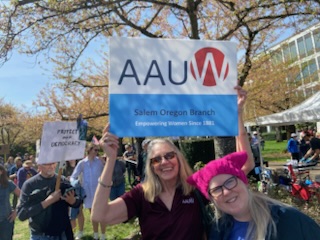Members holding a blude and white AAUW sign at a protest at Oregon State Capital.