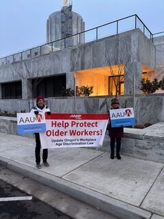 Members holding signs and banners outside the Oregon State Capital building.